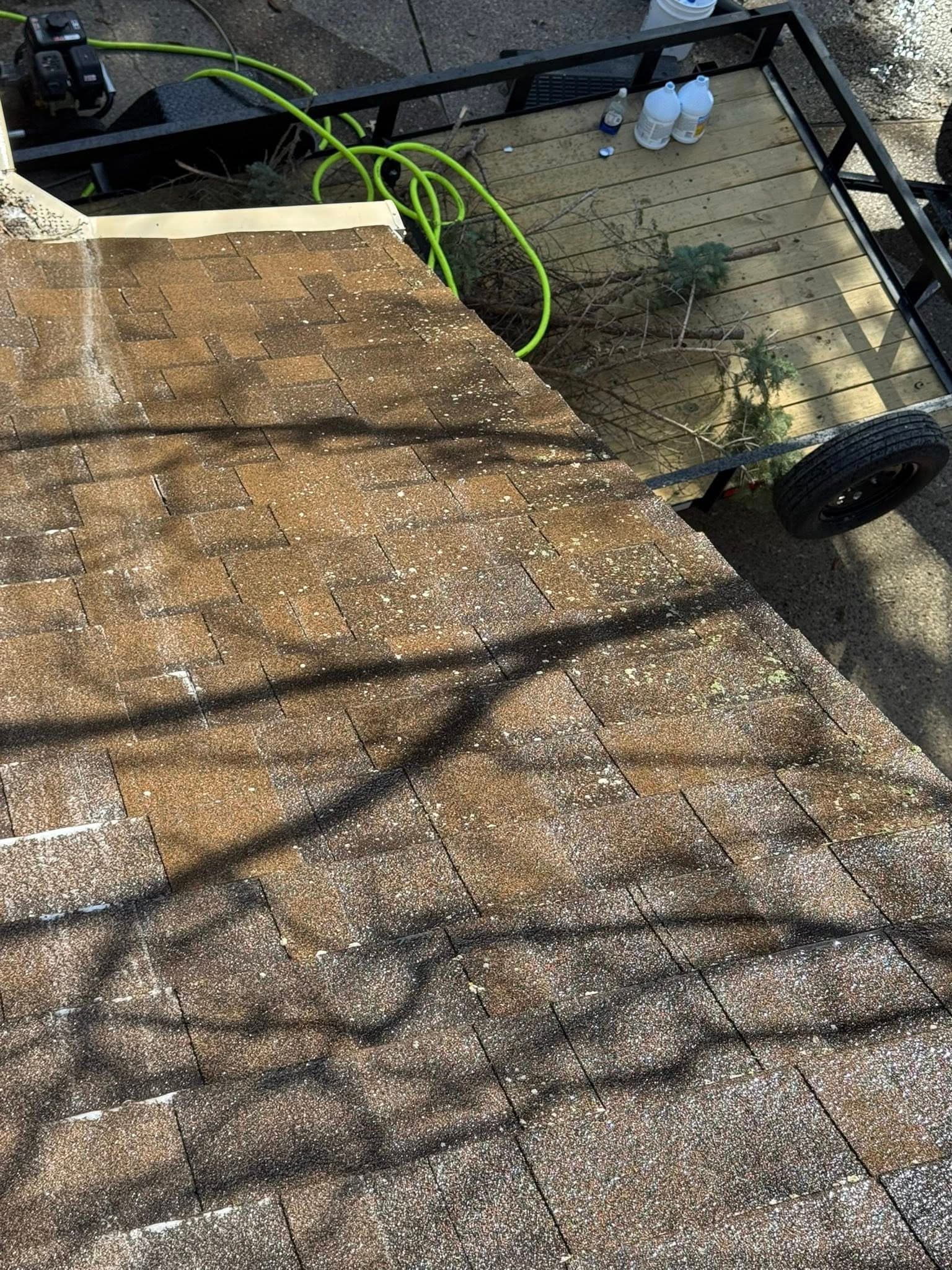 Looking down from the roofline at the work trailer during a gutter job