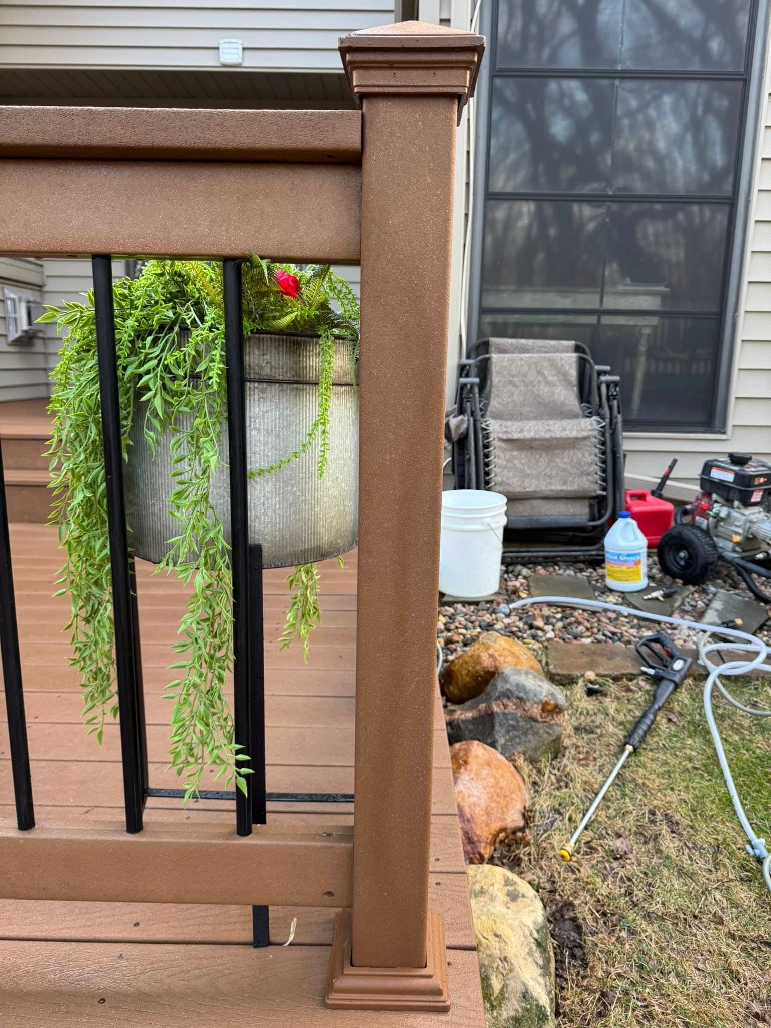 The pressure washer staged on a backyard deck, hose run and ready